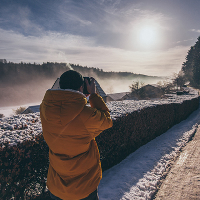 Man Photographing Winter Landscape.