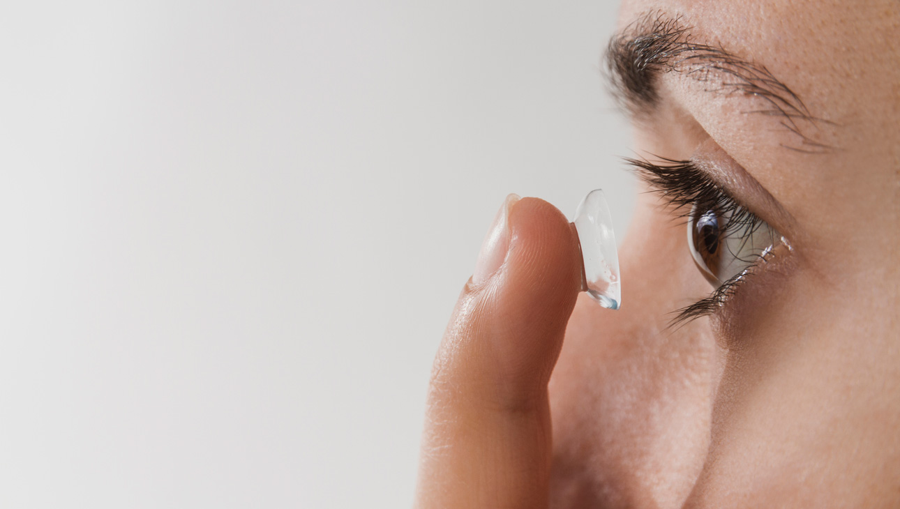 Person Inserting A Contact Lens.