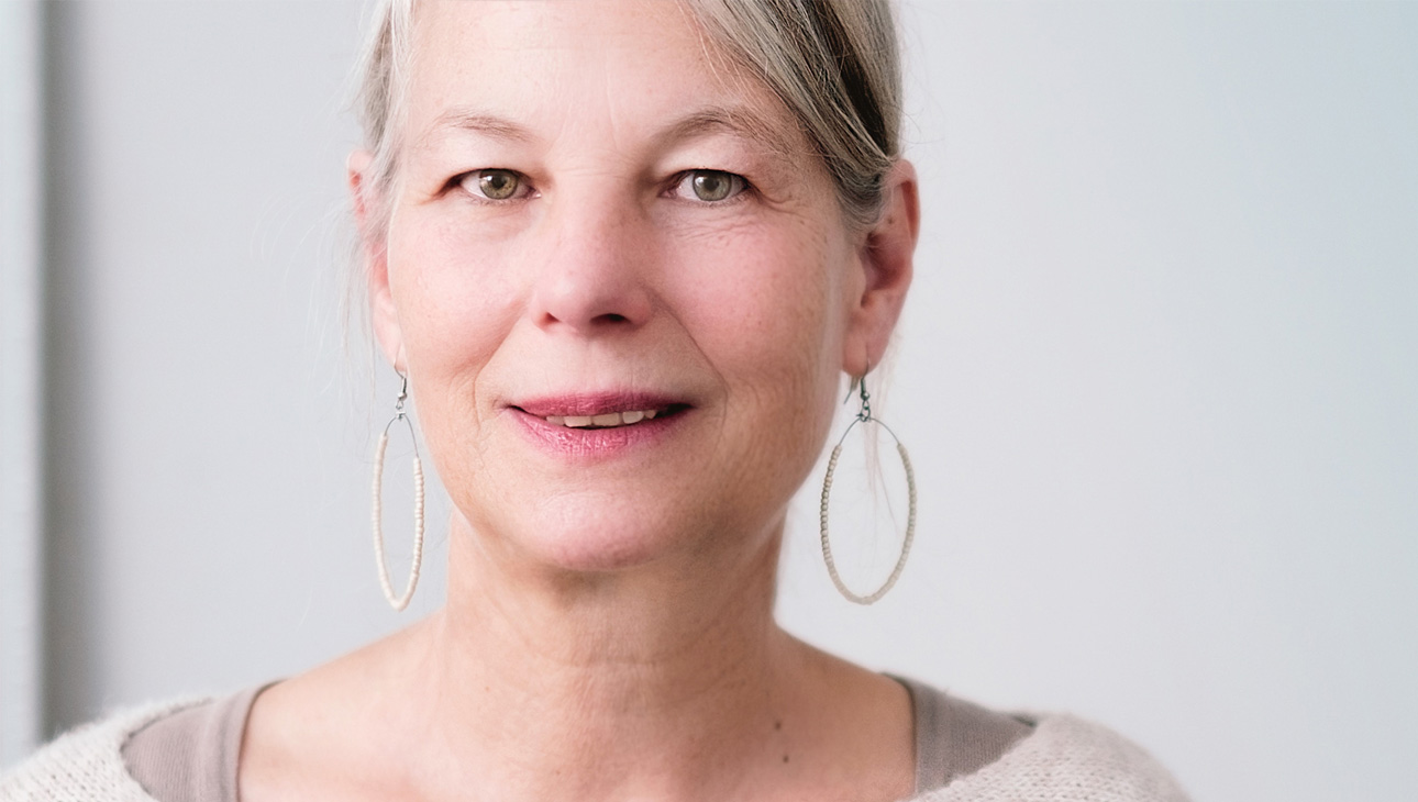 Older Woman With Hoop Earrings And Dry Eyes.