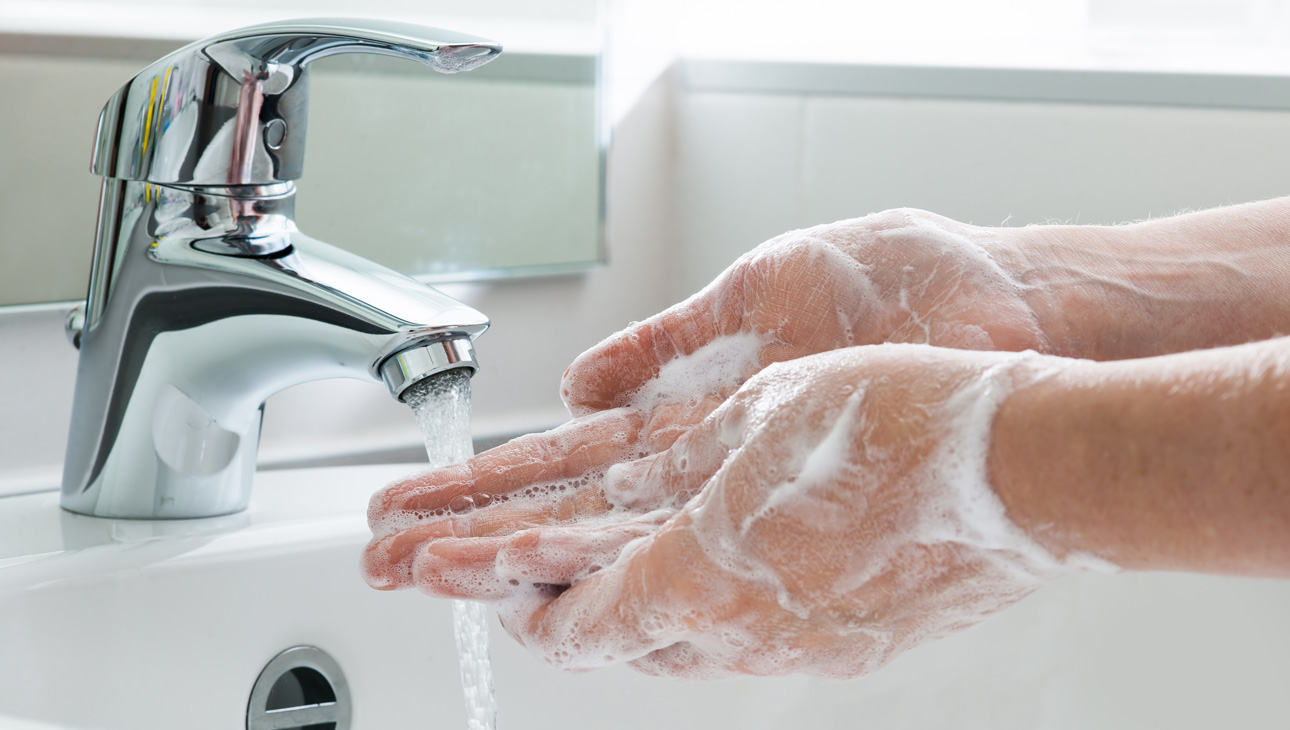 Soapy Hands Being Washed Under A Tap To Prevent Eye Infections.