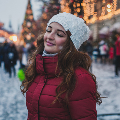 Woman Smiling With Eyes Closed In The Snow.