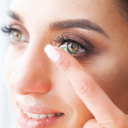 Woman Inserting Contact Lens.